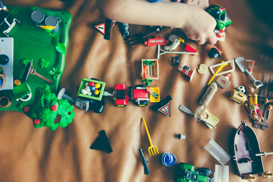 child playing with assortment of toys